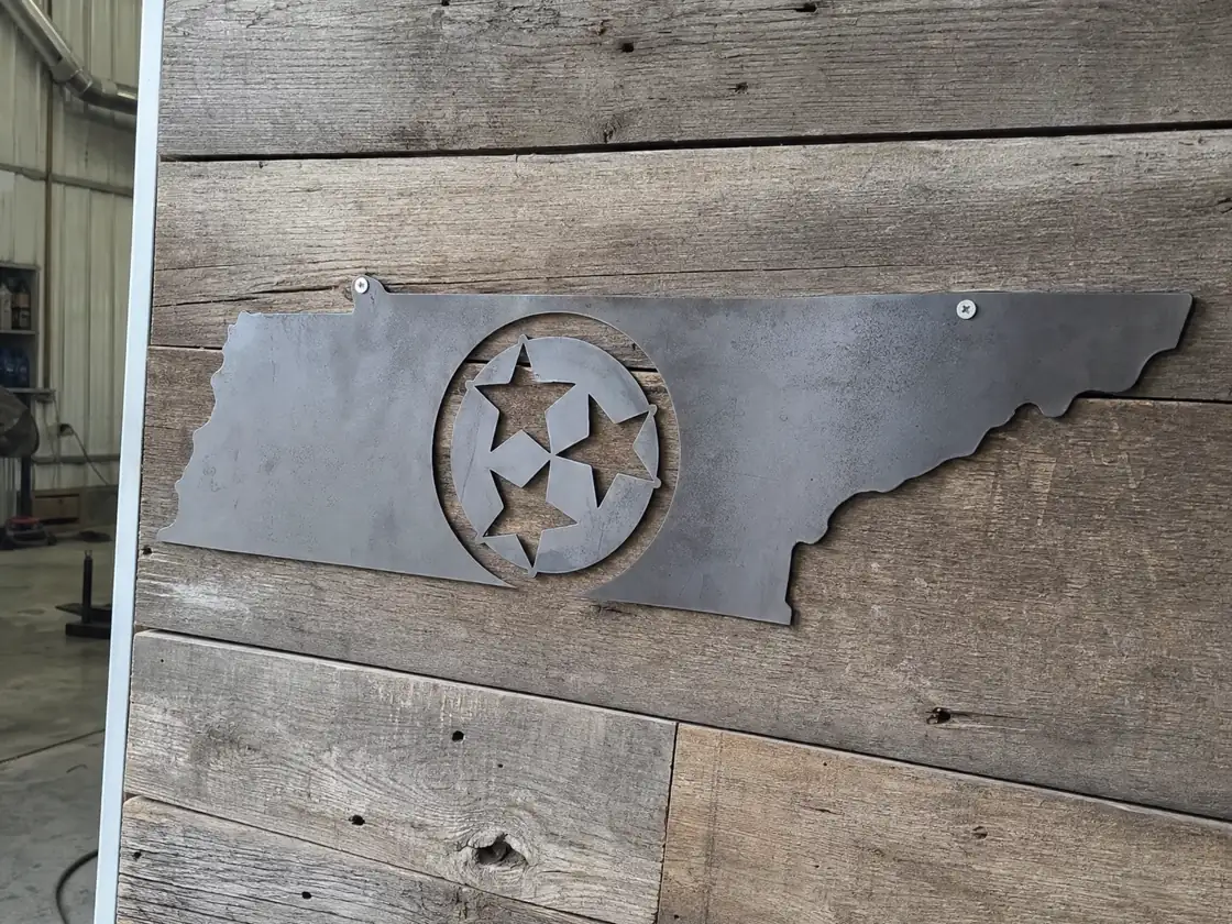 A Tennessee outline sign with the tri-star cut through it, laser-cut from steel